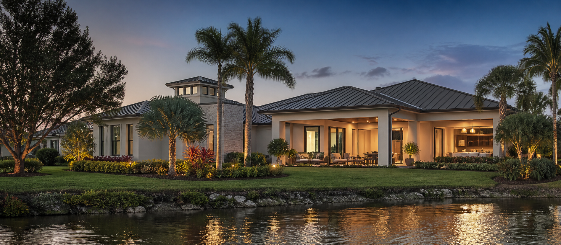 A refined Sarasota residence glowing at dusk beside the water